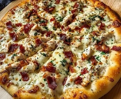 Delicious homemade Chicken Bacon Ranch Pizza topped with fresh ingredients.