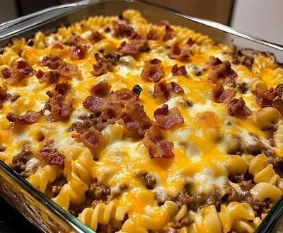 Bacon cheeseburger pasta bake topped with melted cheese and crispy bacon
