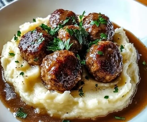 Salisbury steak meatballs served with garlic herb mashed potatoes