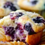 Freshly baked blueberry muffins with a golden brown top and juicy blueberries