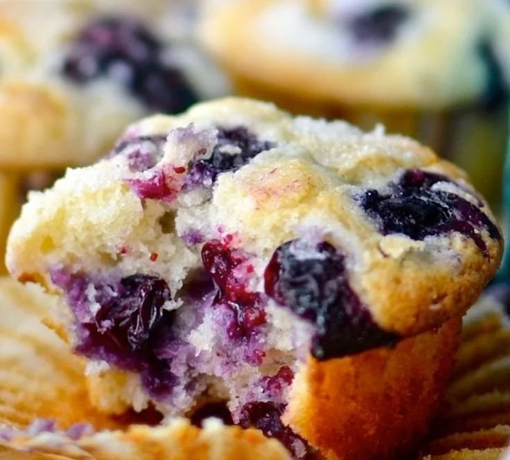 Freshly baked blueberry muffins with a golden brown top and juicy blueberries