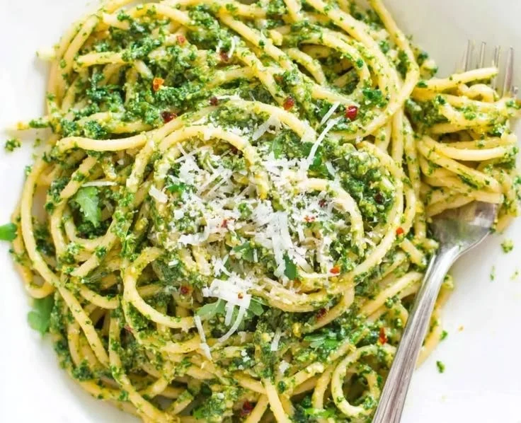 Delicious homemade Arugula Basil Pesto served in a bowl with fresh ingredients.