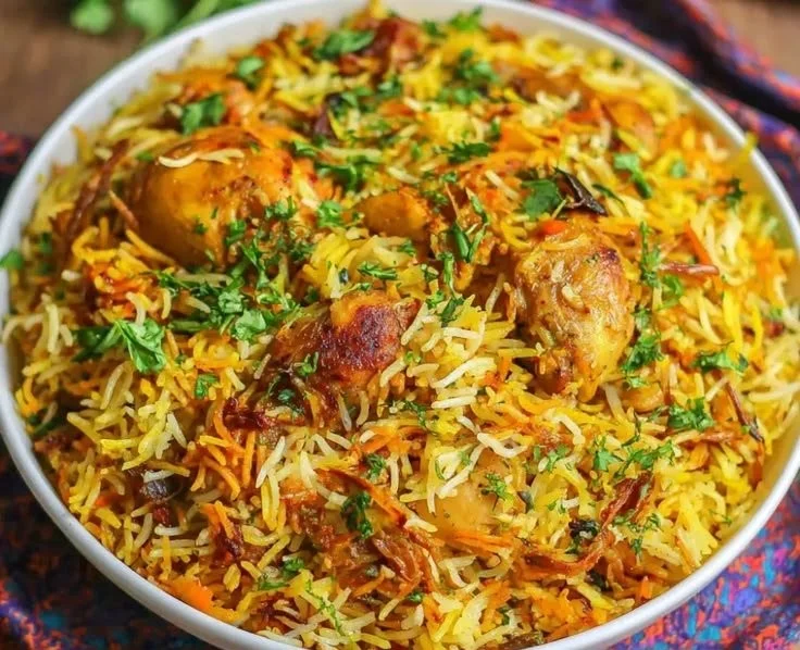 Delicious authentic chicken biryani with spices and herbs served in a traditional bowl