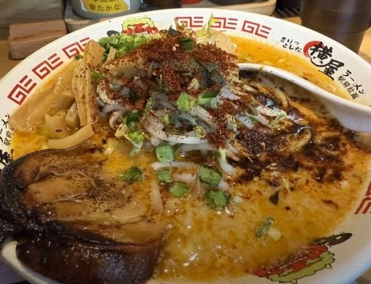 Bowl of homemade Tonkotsu Ramen topped with scallions and soft-boiled egg