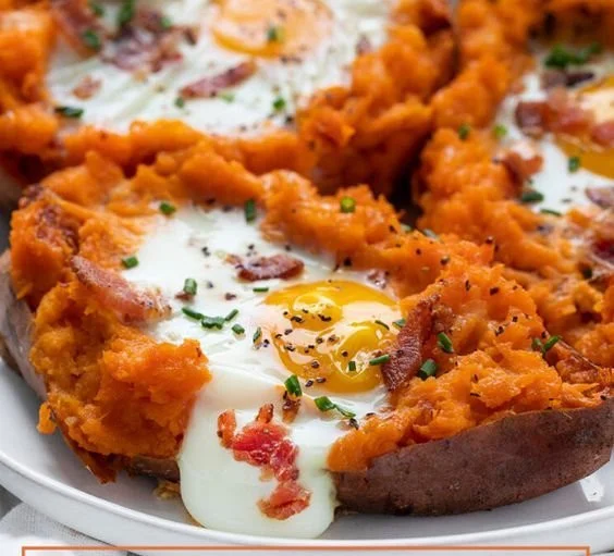 A plate of delicious breakfast sweet potatoes topped with nuts and berries.