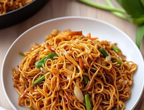 Delicious Cantonese Chow Mein with fresh vegetables and savory sauce.
