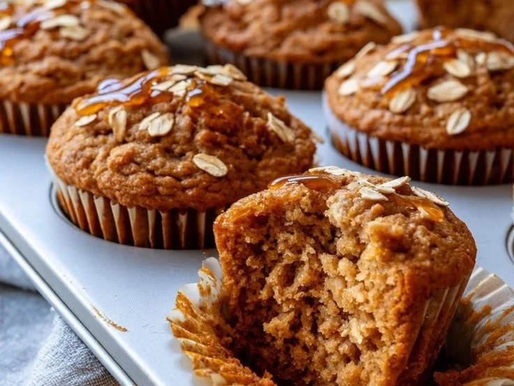 Freshly baked cinnamon banana oat muffins on a cooling rack