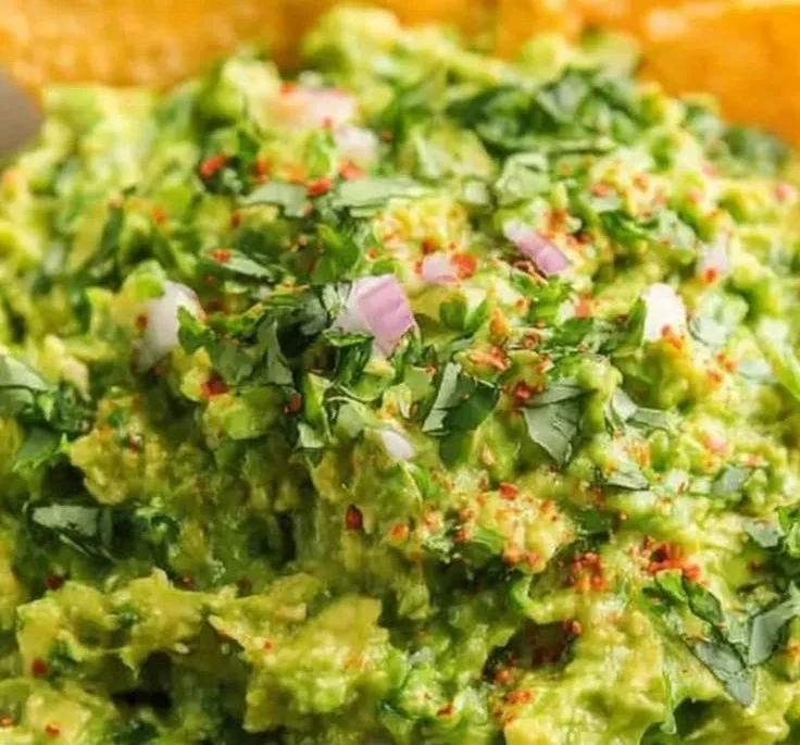 Bowl of classic guacamole made with fresh avocados and seasonings