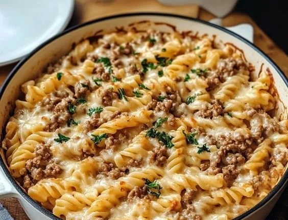 Creamy ground beef pasta served in a bowl with fresh herbs