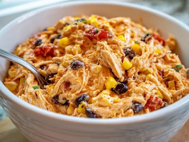 Delicious Crockpot Fiesta Chicken served in a bowl with fresh toppings