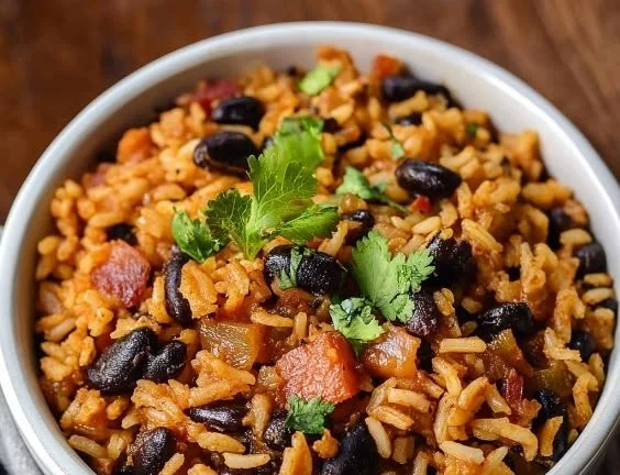 Cuban black beans and rice served in a colorful bowl with garnishes.