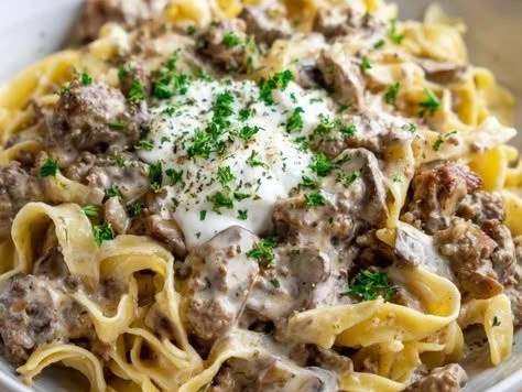 Delicious ground beef stroganoff served over egg noodles in a creamy sauce