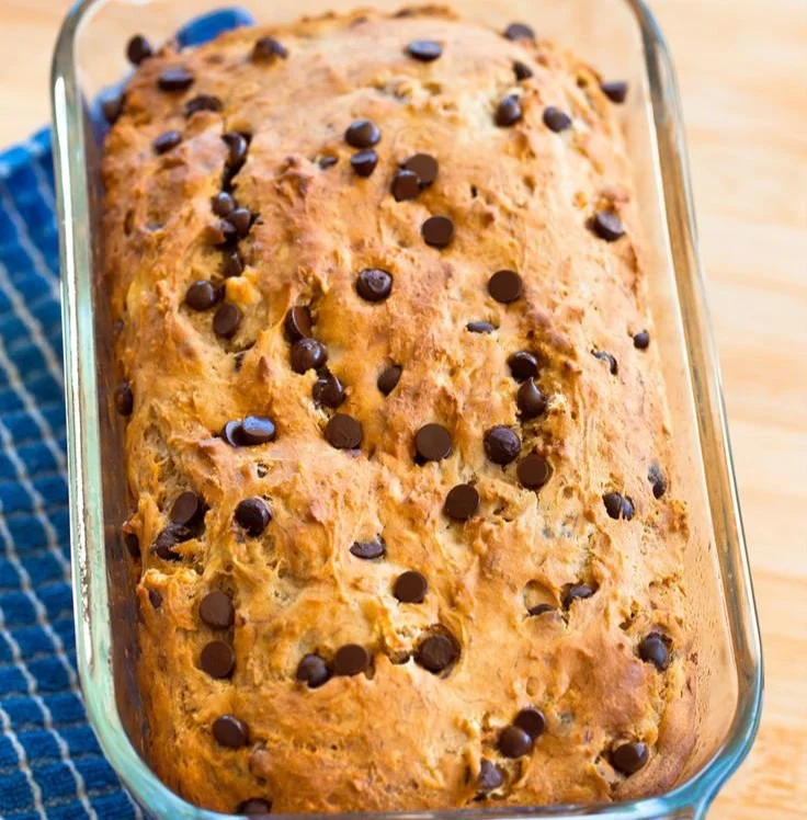 A slice of high-protein banana bread with nutritious ingredients.