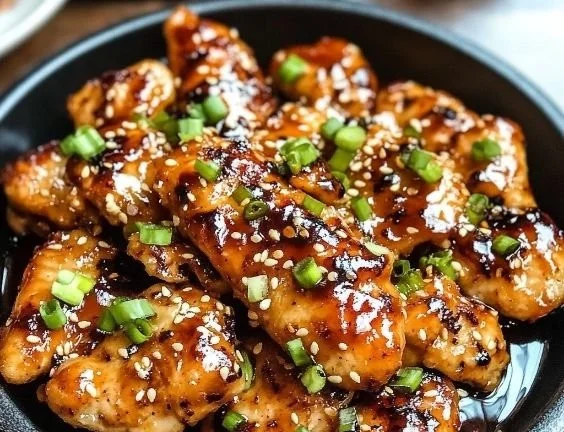 Deliciously prepared Korean chicken breasts garnished with sesame seeds.