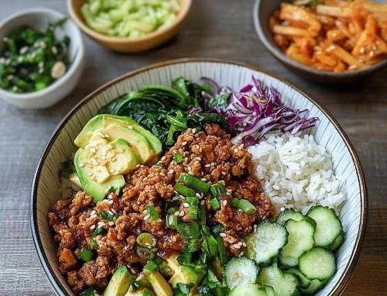 Bowl of Korean ground turkey rice topped with vegetables and sesame seeds