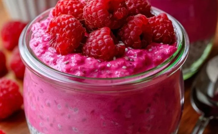 Quick vanilla raspberry chia pudding in a glass topped with fresh raspberries