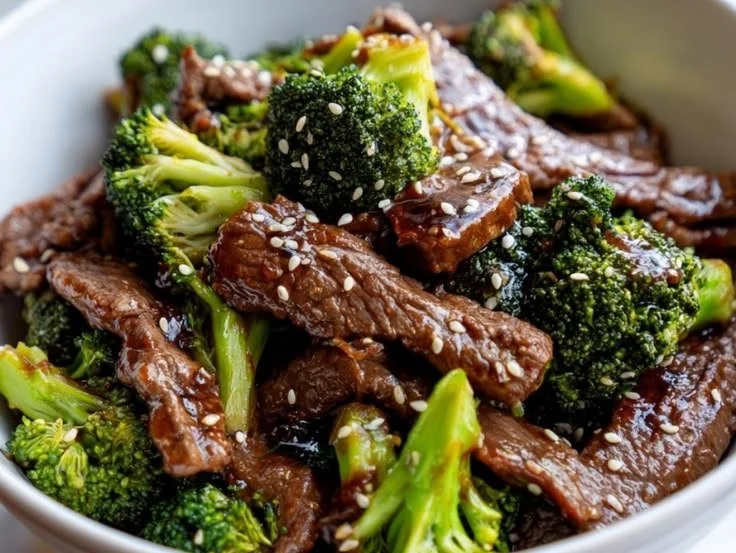 Delicious slow cooker beef and broccoli served on a plate with rice.