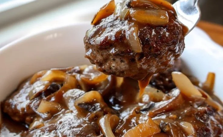Slow Cooker Salisbury Steak served on a plate with gravy and vegetables