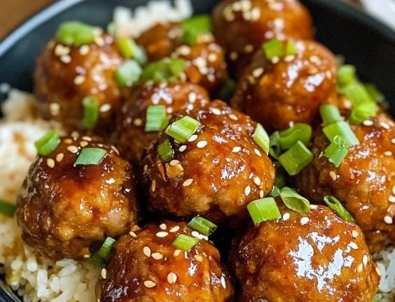 Sweet and Spicy Asian Turkey Meatballs served with dipping sauce and garnished.