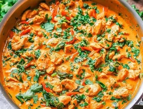 Thai Coconut Chicken Curry served with rice and fresh herbs