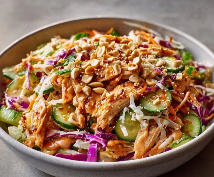 A vibrant Bang Bang Chicken Salad served in a bowl with fresh ingredients