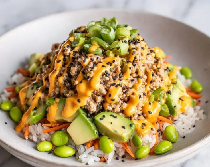 Bang Bang Ground Turkey Rice Bowl served with fresh vegetables and spicy sauce