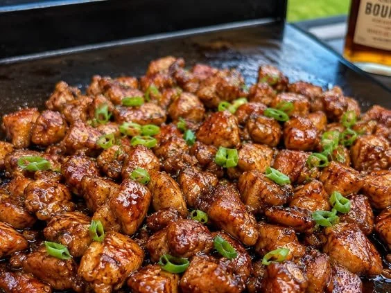 Delicious Blackstone Bourbon Chicken served on a grill.
