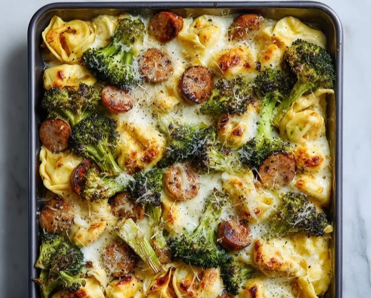 Baked Broccoli Tortellini dish served on a white plate with melted cheese