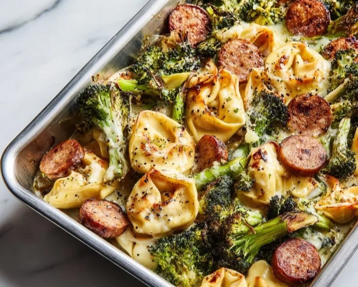 Baked Broccoli Tortellini dish topped with cheese and herbs