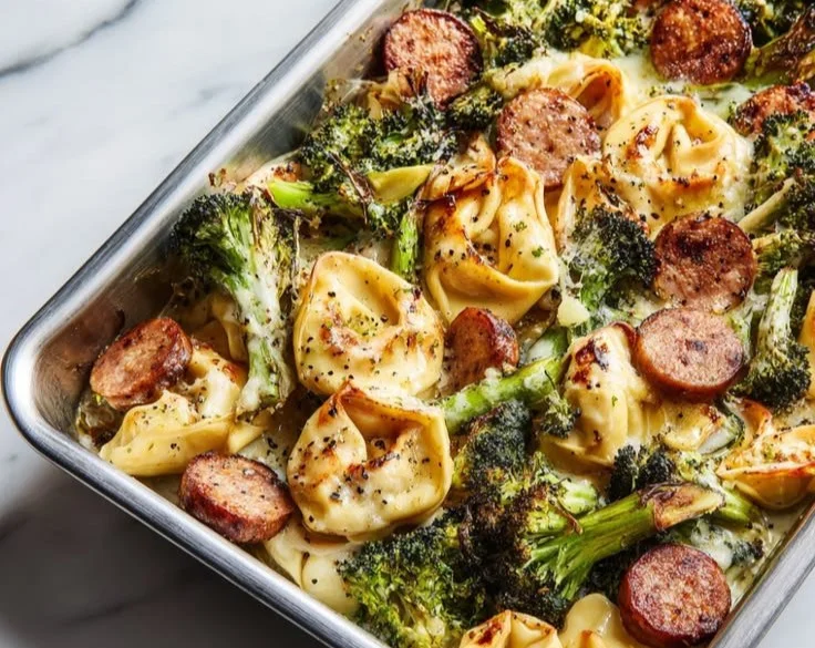 Broccoli Tortellini Bake on a sheet pan with melted cheese and fresh broccoli