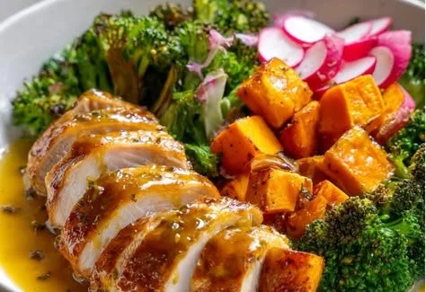 Healthy bowl with Maple Dijon Chicken, fresh vegetables, and grains.