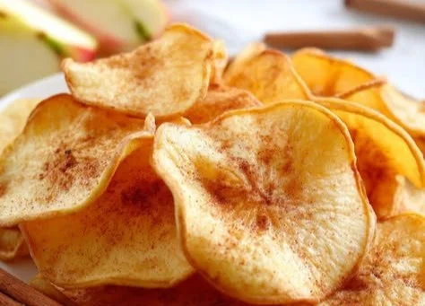 Crispy air fryer apple chips sprinkled with cinnamon, healthy snack option