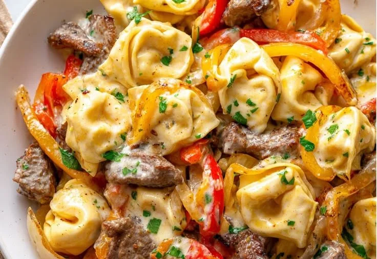1-pan cheesesteak tortellini with provolone cheese, ready to serve for dinner