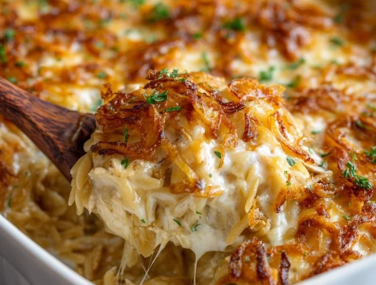 Delicious French Onion Chicken Orzo Casserole topped with melted cheese and herbs