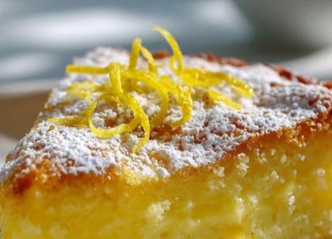 A slice of Grandma's Italian Lemon Custard Cake with lemon zest on top.