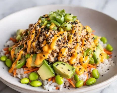 Delicious high-protein ground turkey rice bowl topped with fresh vegetables.