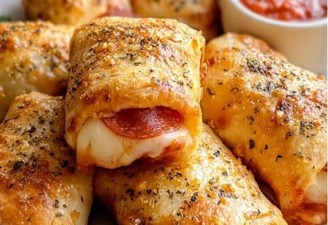 Crispy air fryer pizza rolls served with dipping sauce on a plate