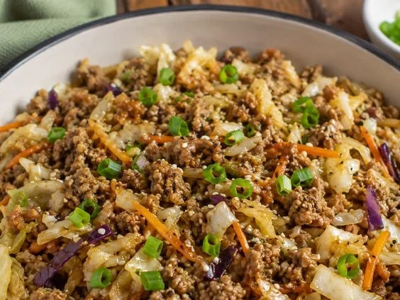Keto-friendly egg roll bowl with vegetables and proteins in a bowl