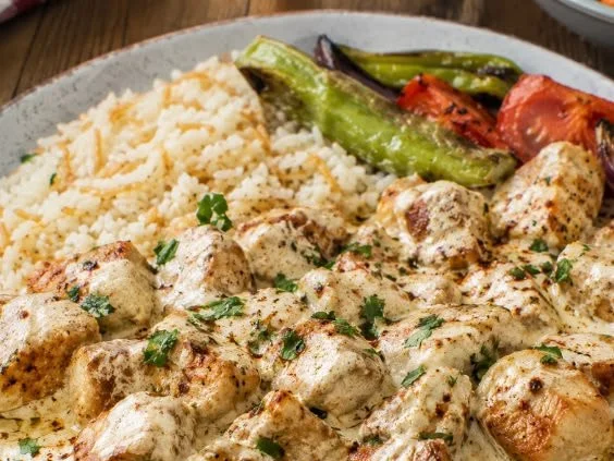 Delicious Turkish chicken in creamy white sauce, garnished and ready to serve.